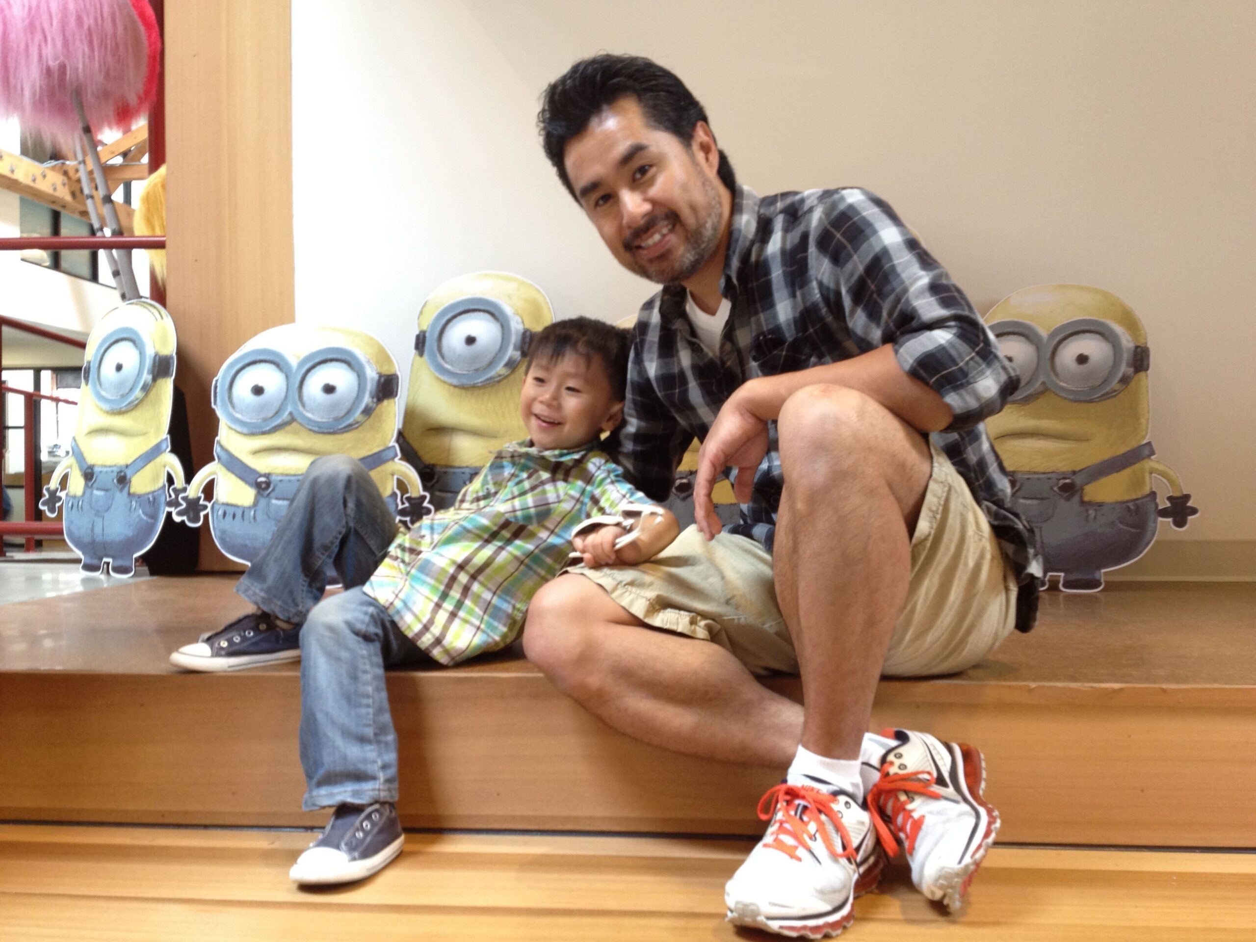 Sean Lee and his young son with the Minions.